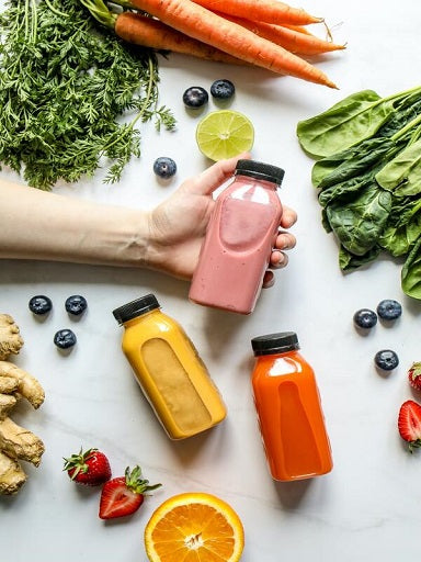 healthy smoothies in jars on the table, surrounded by ingredients