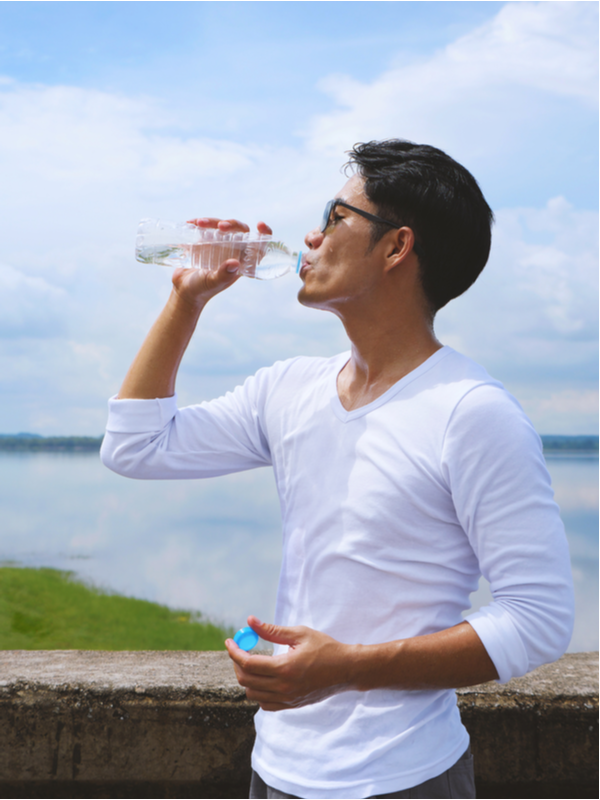 Young man taking a water break from outdoor training