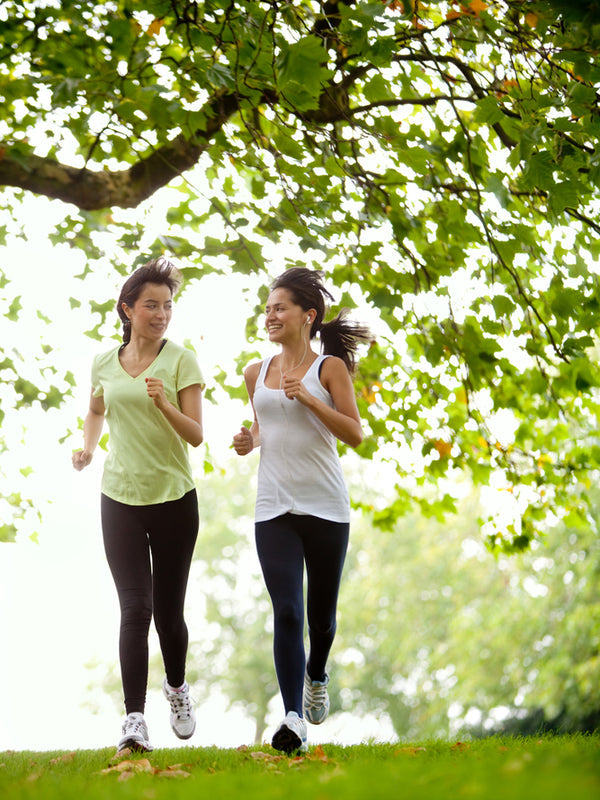 Two young woman jogging in the park